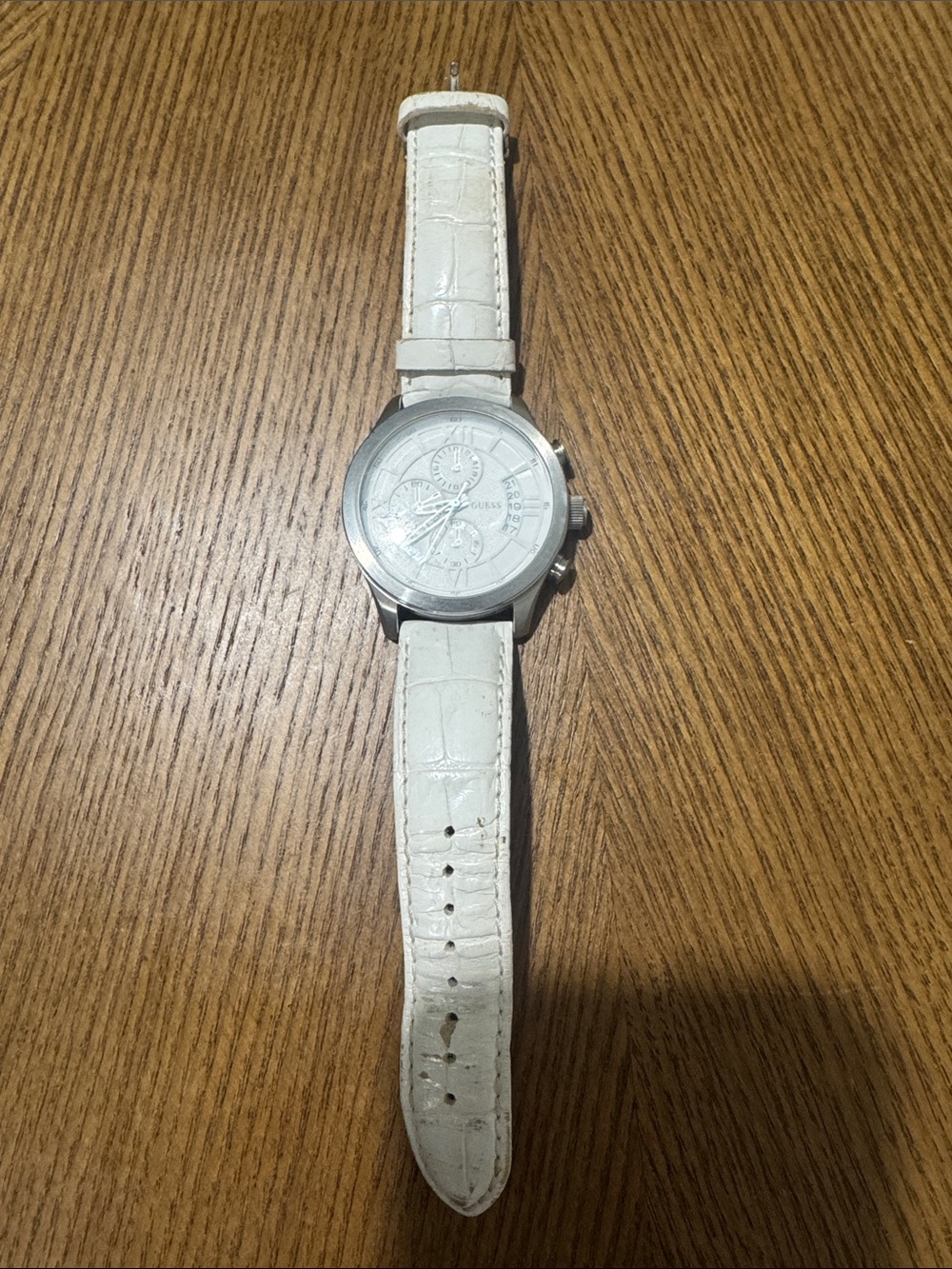 Guess men’s white leather strap watch